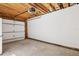 Spacious garage with exposed wood beams, large white wall, and concrete floor at 106 19Th Ave, St Pete Beach, FL 33706