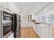 Bright kitchen boasts white cabinets, stainless appliances, gas range, and butcher block countertop at 106 19Th Ave, St Pete Beach, FL 33706
