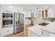 Modern kitchen with stainless steel appliances, white cabinets, and quartz countertops at 106 19Th Ave, St Pete Beach, FL 33706