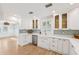 Modern kitchen with white cabinets, quartz countertops, farmhouse sink, and stainless steel appliances at 106 19Th Ave, St Pete Beach, FL 33706
