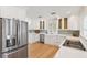 Modern kitchen with stainless steel appliances, white cabinets, and quartz countertops at 106 19Th Ave, St Pete Beach, FL 33706