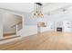 Open-concept living space featuring hardwood floors, fireplace, and modern lighting at 106 19Th Ave, St Pete Beach, FL 33706