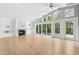Bright living room with fireplace, built-in shelving, and sliding doors to the pool area at 106 19Th Ave, St Pete Beach, FL 33706