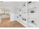Bright living room showcases custom built-in shelving and arched entryway to kitchen at 106 19Th Ave, St Pete Beach, FL 33706
