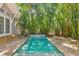 A backyard oasis featuring a sparkling pool surrounded by lush tropical landscaping at 106 19Th Ave, St Pete Beach, FL 33706