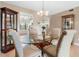 Bright dining room with glass table and four chairs, adjacent to kitchen at 5775 Park N St # 411, St Petersburg, FL 33709