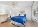 Bright bedroom with a double bed, dresser, and large window at 5775 Park N St # 411, St Petersburg, FL 33709