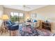 Cozy living room featuring a sofa, armchair, and a large area rug at 5775 Park N St # 411, St Petersburg, FL 33709