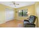 Bedroom with yellow walls, ceiling fan, and large closet at 5775 Park N St # 411, St Petersburg, FL 33709