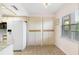 White kitchen with granite countertops and built-in storage at 5775 Park N St # 411, St Petersburg, FL 33709
