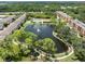 Aerial view of community with lake, pool, tennis courts, and building at 5775 Park N St # 411, St Petersburg, FL 33709