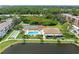Aerial view of community pool, tennis, shuffleboard courts, and clubhouse at 5775 Park N St # 411, St Petersburg, FL 33709