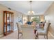 Bright dining area with glass table and four chairs at 5775 Park N St # 411, St Petersburg, FL 33709