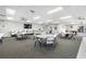 Community room with tables, chairs, and a TV, perfect for gatherings at 5775 Park N St # 411, St Petersburg, FL 33709