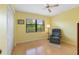 Bedroom with yellow walls, ceiling fan, and recliner at 5775 Park N St # 411, St Petersburg, FL 33709