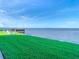 Stunning waterfront view with a dock and lawn at 2570 Gary Cir # 3, Dunedin, FL 34698