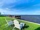 Relaxing waterfront view with chairs and dock at 2570 Gary Cir # 3, Dunedin, FL 34698