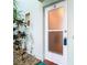 Condo unit's front door with frosted glass panels and adjacent landscaping at 2570 Gary Cir # 3, Dunedin, FL 34698