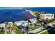 Aerial view showing a waterfront property with a condo building and parking at 2570 Gary Cir # 3, Dunedin, FL 34698