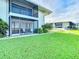 Ground level view of condo building and lawn at 2570 Gary Cir # 3, Dunedin, FL 34698
