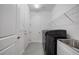 Bright laundry room with built-in shelving and a sink at 3472 Great Banyan Way, Wesley Chapel, FL 33543