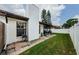 Landscaped backyard with patio and grill, adjacent to home at 2014 Montego Ct, Oldsmar, FL 34677
