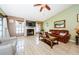 Living room with comfortable seating, a fireplace, and a large TV at 2014 Montego Ct, Oldsmar, FL 34677