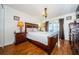 Main bedroom with wood flooring, large bed, and access to patio at 2014 Montego Ct, Oldsmar, FL 34677