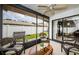 Relaxing screened porch with wicker furniture and backyard access at 2014 Montego Ct, Oldsmar, FL 34677