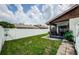 Large backyard with grassy area, patio, and screened porch at 2014 Montego Ct, Oldsmar, FL 34677
