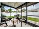 Relaxing screened porch with wicker furniture and view of backyard at 2014 Montego Ct, Oldsmar, FL 34677