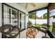 Bright screened porch features wicker furniture and access to backyard at 2014 Montego Ct, Oldsmar, FL 34677