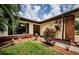 Side view of the house, highlighting landscaping and entryway at 2014 Montego Ct, Oldsmar, FL 34677