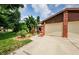 Brick home with a two-car garage and well-maintained landscaping at 2014 Montego Ct, Oldsmar, FL 34677