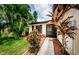 Front entrance with lush landscaping, creating a welcoming atmosphere at 2014 Montego Ct, Oldsmar, FL 34677