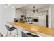 Kitchen with light wood countertops and white cabinets at 1515 Pinellas Bayway S # 65, St Petersburg, FL 33715