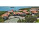 Aerial view of waterfront community with tennis court and pool at 1515 Pinellas Bayway S # 65, St Petersburg, FL 33715