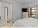 Bedroom with access to a bathroom and dresser at 1515 Pinellas Bayway S # 65, St Petersburg, FL 33715