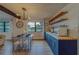 Modern kitchen with blue cabinetry, wood countertops, and stylish shelving at 1420 54Th N Ave, St Petersburg, FL 33703