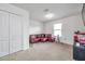 Bonus room with red sectional sofa and media center at 116 Caladium Ct, Bradenton, FL 34212