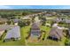 Aerial view showcasing a community of homes with a lake and lush greenery at 116 Caladium Ct, Bradenton, FL 34212