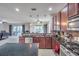 Open kitchen features dark wood cabinets, granite countertops, and stainless steel appliances at 116 Caladium Ct, Bradenton, FL 34212