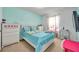 Light and bright bedroom with white furniture and teal bedding at 116 Caladium Ct, Bradenton, FL 34212