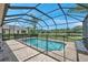 Inviting screened-in pool with safety fence and lounge chair at 116 Caladium Ct, Bradenton, FL 34212