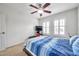 Bedroom with ceiling fan, blue bedding, and plantation shutters at 116 Caladium Ct, Bradenton, FL 34212