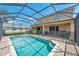 Refreshing, screened-in pool with safety fence and backyard view at 116 Caladium Ct, Bradenton, FL 34212