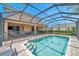 Large, screened-in, refreshing pool with safety fence and patio access at 116 Caladium Ct, Bradenton, FL 34212