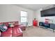 Bonus room with red sectional sofa and large TV at 116 Caladium Ct, Bradenton, FL 34212