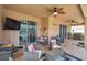 Comfortable covered patio with seating area and large screen TV at 116 Caladium Ct, Bradenton, FL 34212