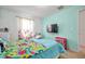 Bedroom with teal walls and a colorful bedspread at 116 Caladium Ct, Bradenton, FL 34212